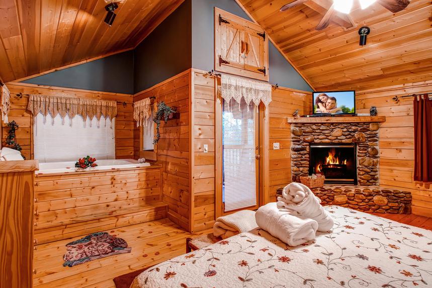 Master bedroom with flat screen tv, gas fireplace and relaxing jacuzzi tub